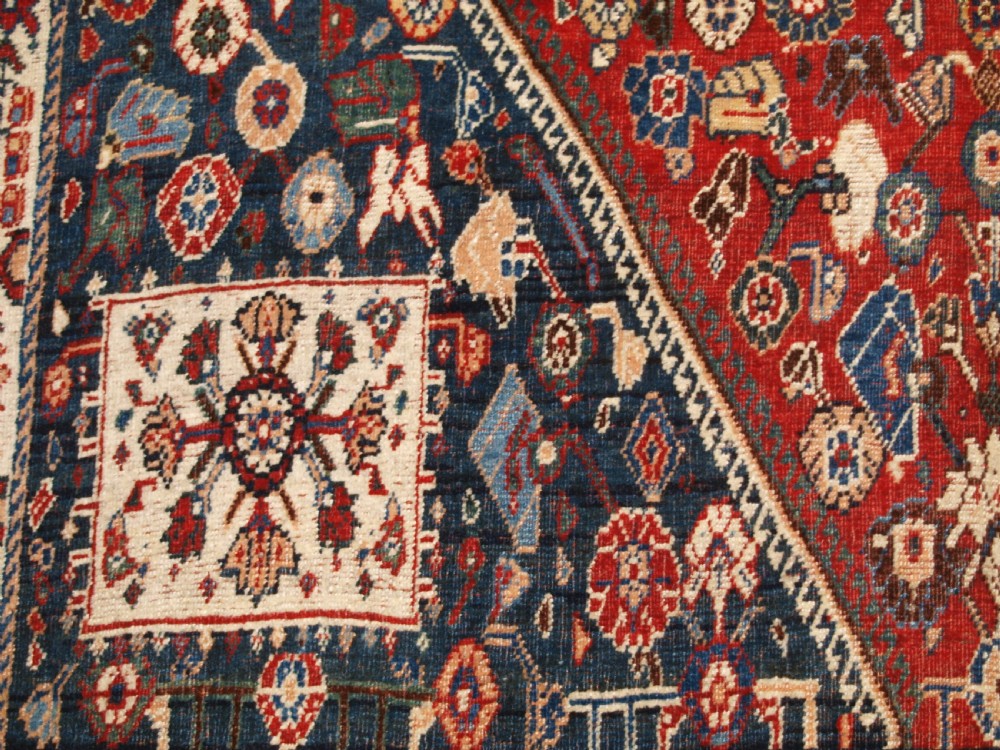 An antique hand-knotted Qashqai Kashkuli wool rug featuring a central red diamond medallion framed by complex floral motifs and multi-band geometric borders. View XIII