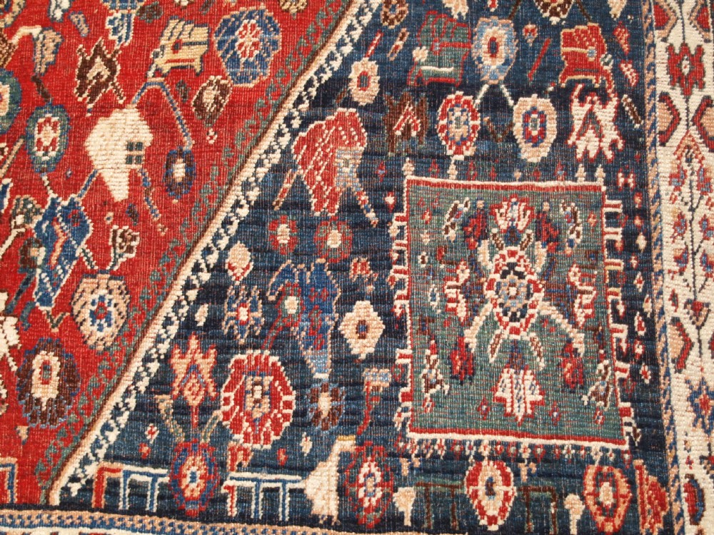 An antique hand-knotted Qashqai Kashkuli wool rug featuring a central red diamond medallion framed by complex floral motifs and multi-band geometric borders. View XIV