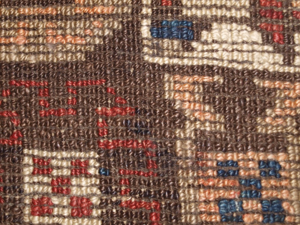 An antique Turkish Bergama rug featuring hand-knotted geometric motifs in shades of terracotta red, navy blue, and cream. View XII