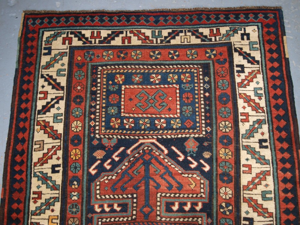 An antique hand-knotted wool Kelardasht runner rug featuring geometric medallions in dark blue, terracotta red, and cream with multi-layered patterned borders. View III