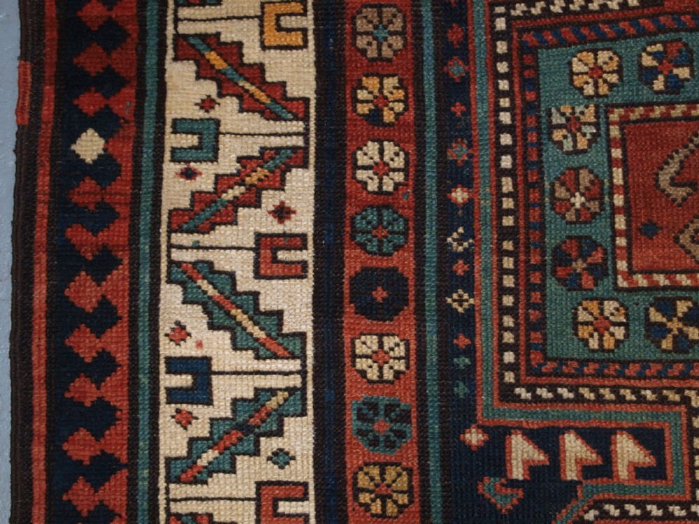 An antique hand-knotted wool Kelardasht runner rug featuring geometric medallions in dark blue, terracotta red, and cream with multi-layered patterned borders. View IX