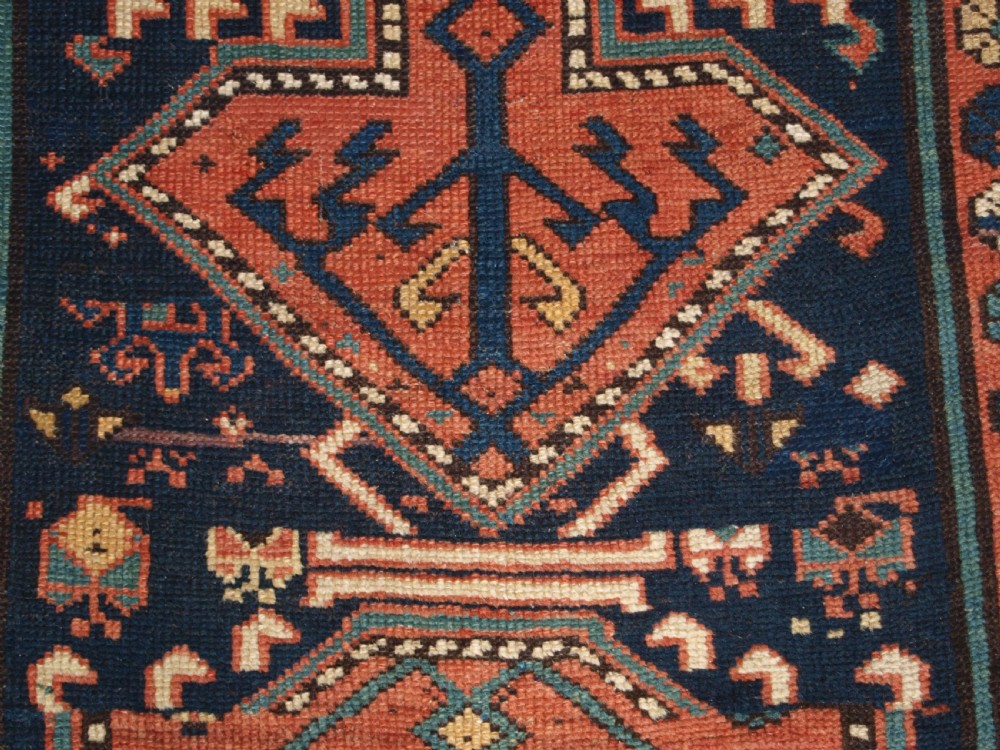 An antique hand-knotted wool Kelardasht runner rug featuring geometric medallions in dark blue, terracotta red, and cream with multi-layered patterned borders. View XI