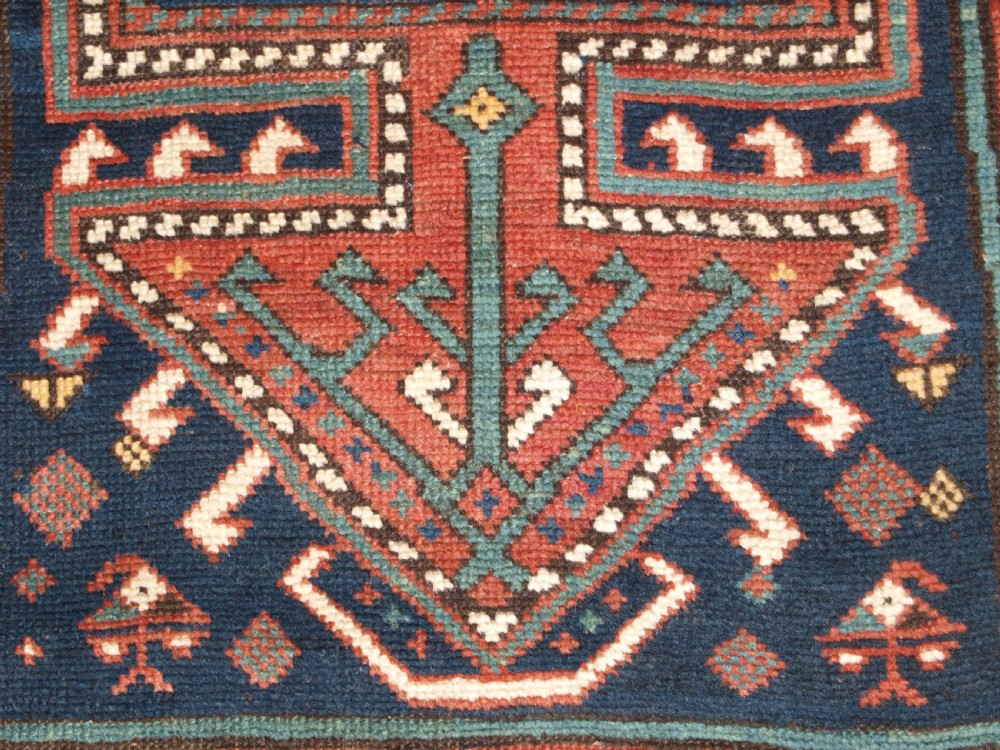 An antique hand-knotted wool Kelardasht runner rug featuring geometric medallions in dark blue, terracotta red, and cream with multi-layered patterned borders. View XII