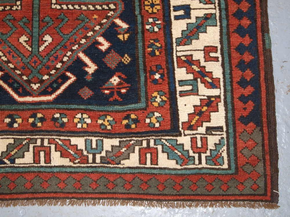 An antique hand-knotted wool Kelardasht runner rug featuring geometric medallions in dark blue, terracotta red, and cream with multi-layered patterned borders. View XIII