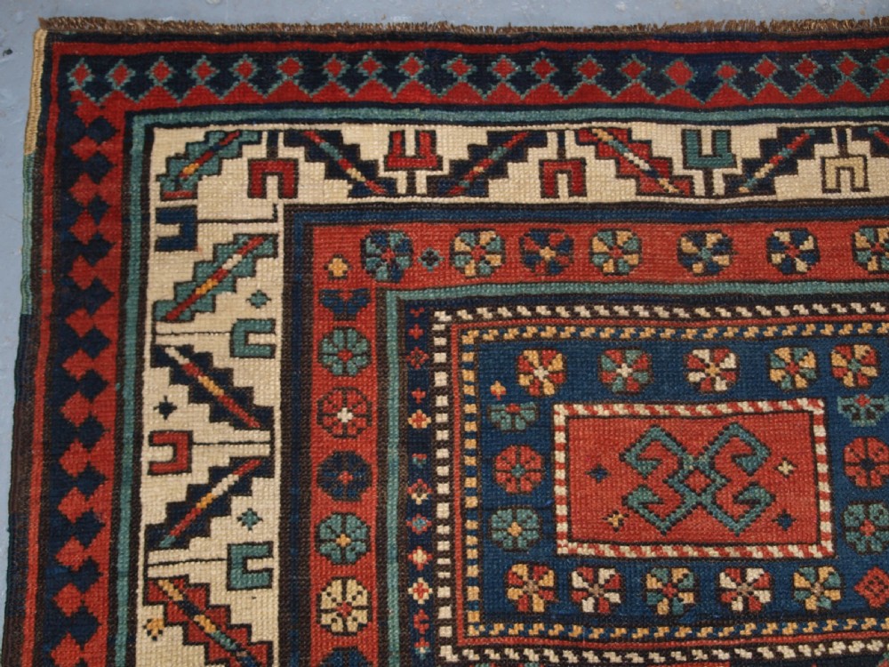 An antique hand-knotted wool Kelardasht runner rug featuring geometric medallions in dark blue, terracotta red, and cream with multi-layered patterned borders. View XIV