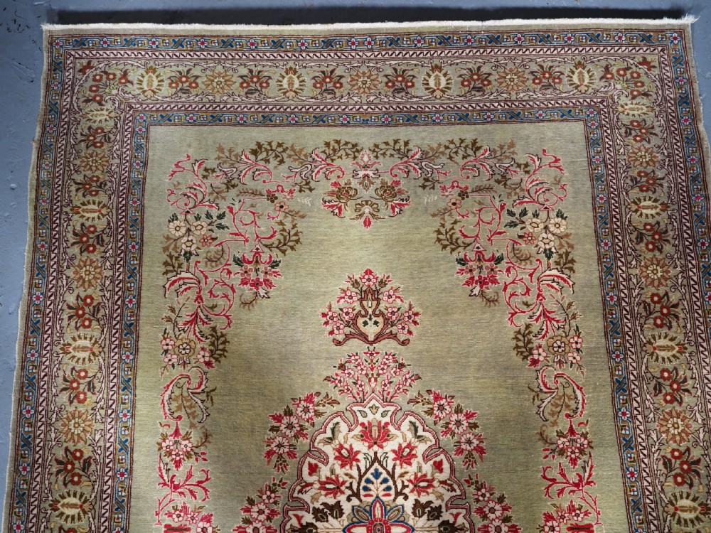ANTIQUE TURKISH HEREKE WOOL RUG WITH SCARCE GREEN GROUND, CIRCA 1900/20. View III