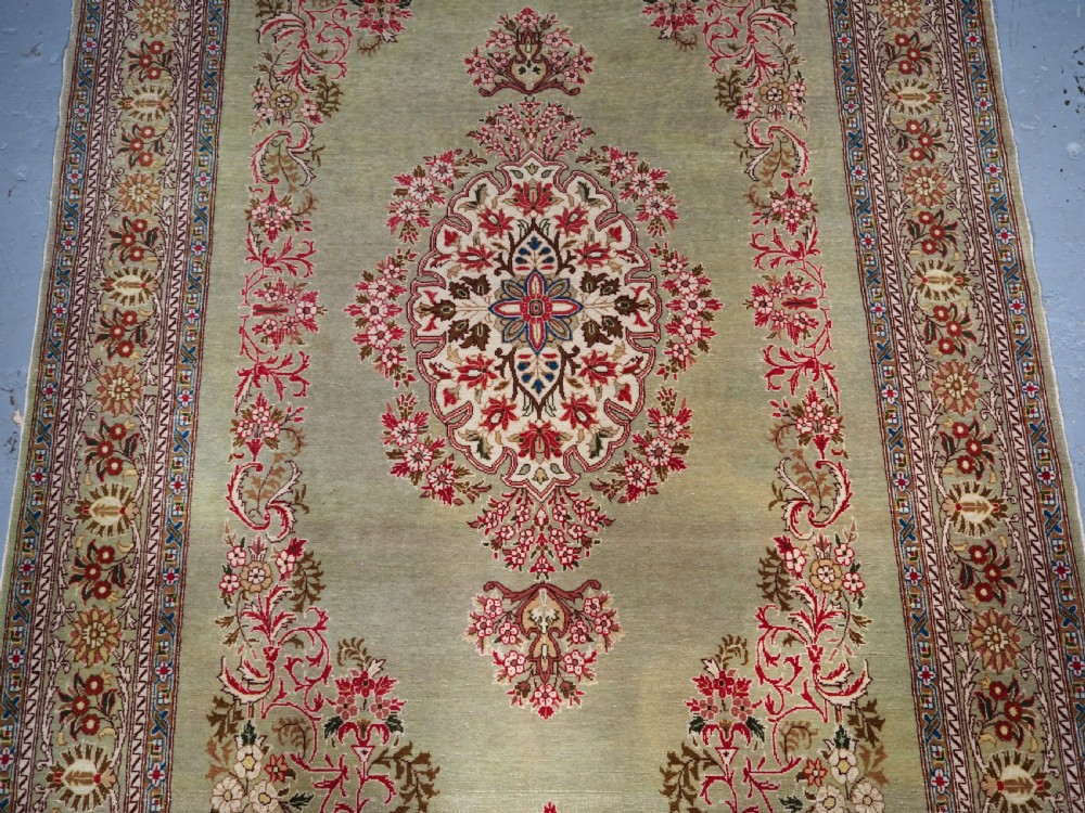 ANTIQUE TURKISH HEREKE WOOL RUG WITH SCARCE GREEN GROUND, CIRCA 1900/20. View IV
