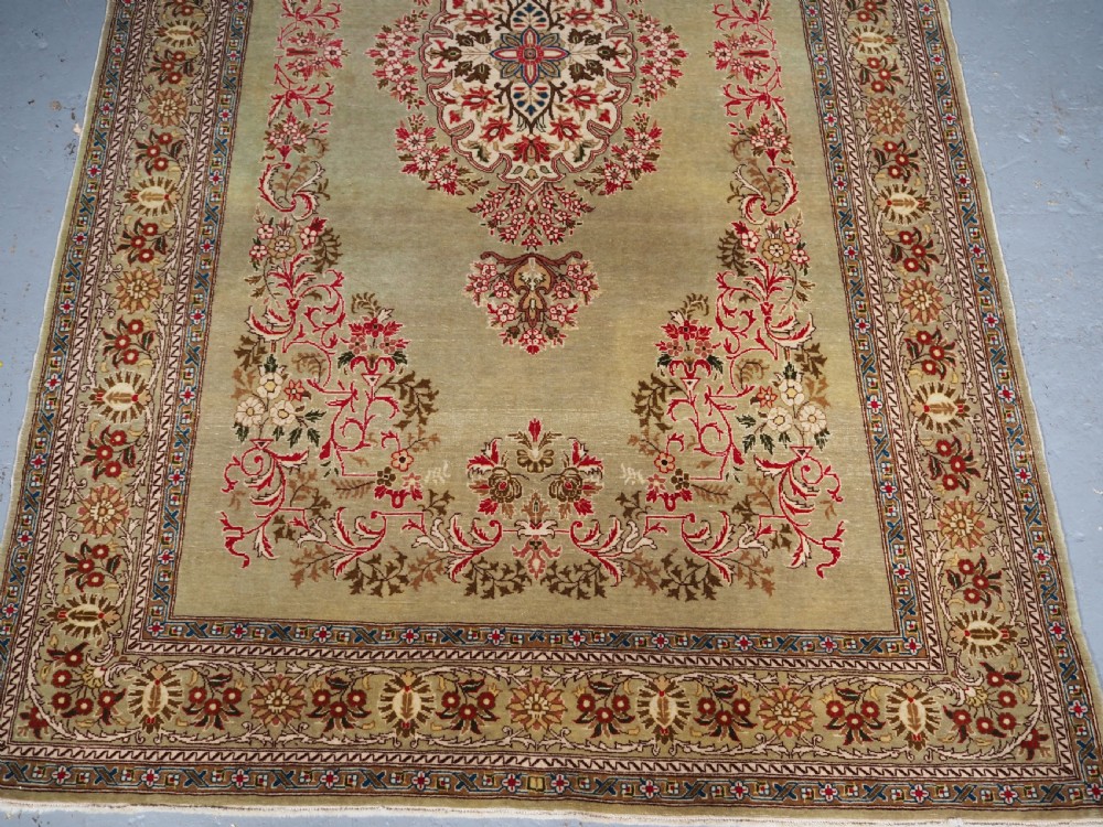ANTIQUE TURKISH HEREKE WOOL RUG WITH SCARCE GREEN GROUND, CIRCA 1900/20. View V