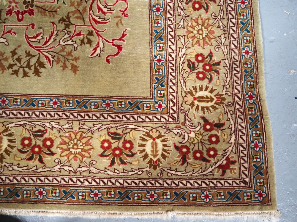 ANTIQUE TURKISH HEREKE WOOL RUG WITH SCARCE GREEN GROUND, CIRCA 1900/20. View X