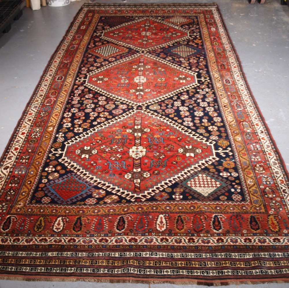 ANTIQUE KELLEH LONG RUG BY THE LURI TRIBE, CLASSIC MEDALLION DESIGN, CIRCA 1900.