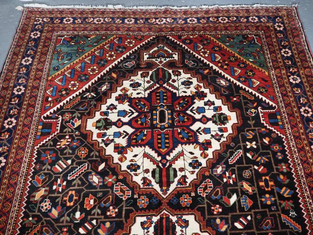 An antique hand-knotted Persian Mahal Kelleh rug featuring three ivory diamond medallions set against a navy blue field with detailed floral borders. View II