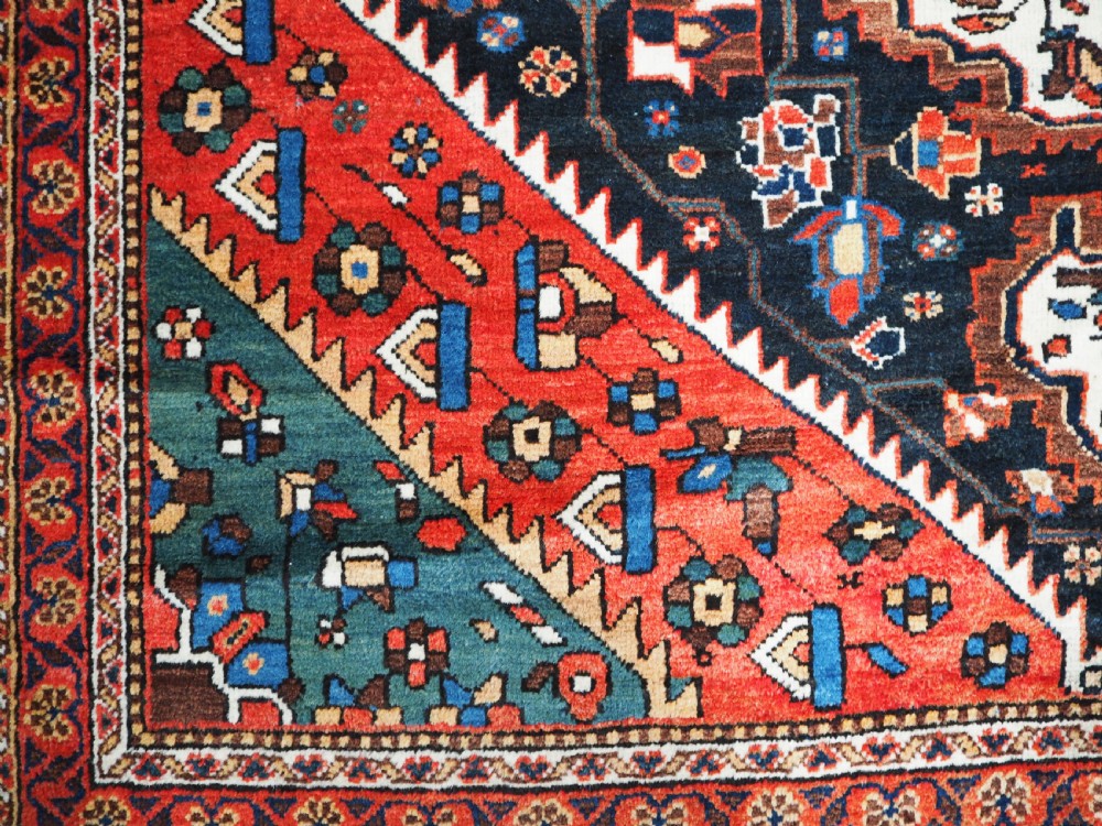 An antique hand-knotted Persian Mahal Kelleh rug featuring three ivory diamond medallions set against a navy blue field with detailed floral borders. View XIII