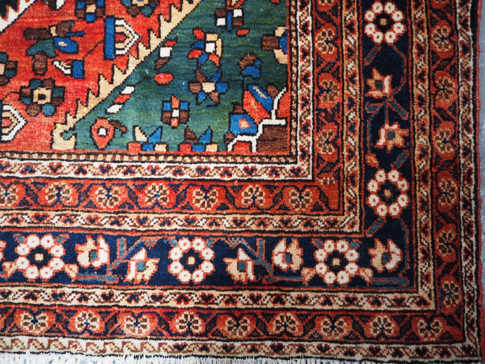 An antique hand-knotted Persian Mahal Kelleh rug featuring three ivory diamond medallions set against a navy blue field with detailed floral borders. View XIV