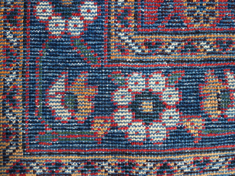 An antique hand-knotted Persian Mahal Kelleh rug featuring three ivory diamond medallions set against a navy blue field with detailed floral borders. View XV