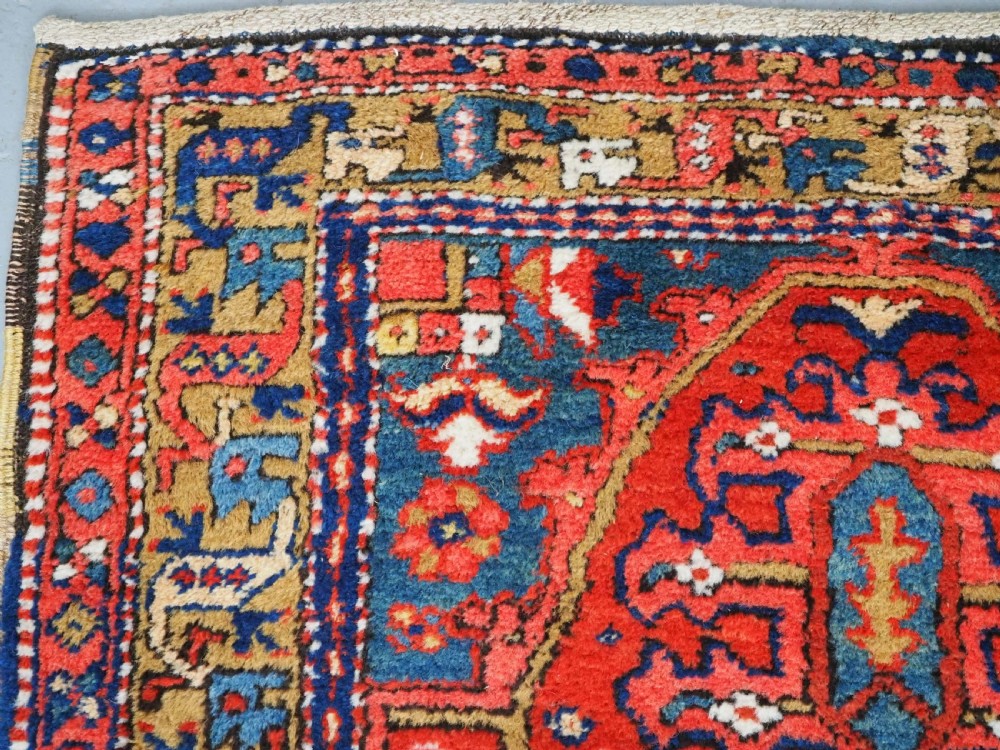A long hand-knotted Persian Heriz carpet runner featuring geometric diamond medallions in navy blue and terracotta red wool. View VIII