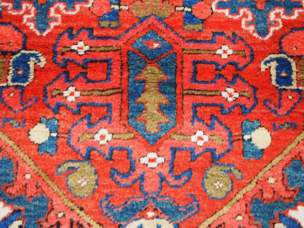 A long hand-knotted Persian Heriz carpet runner featuring geometric diamond medallions in navy blue and terracotta red wool. View XIV