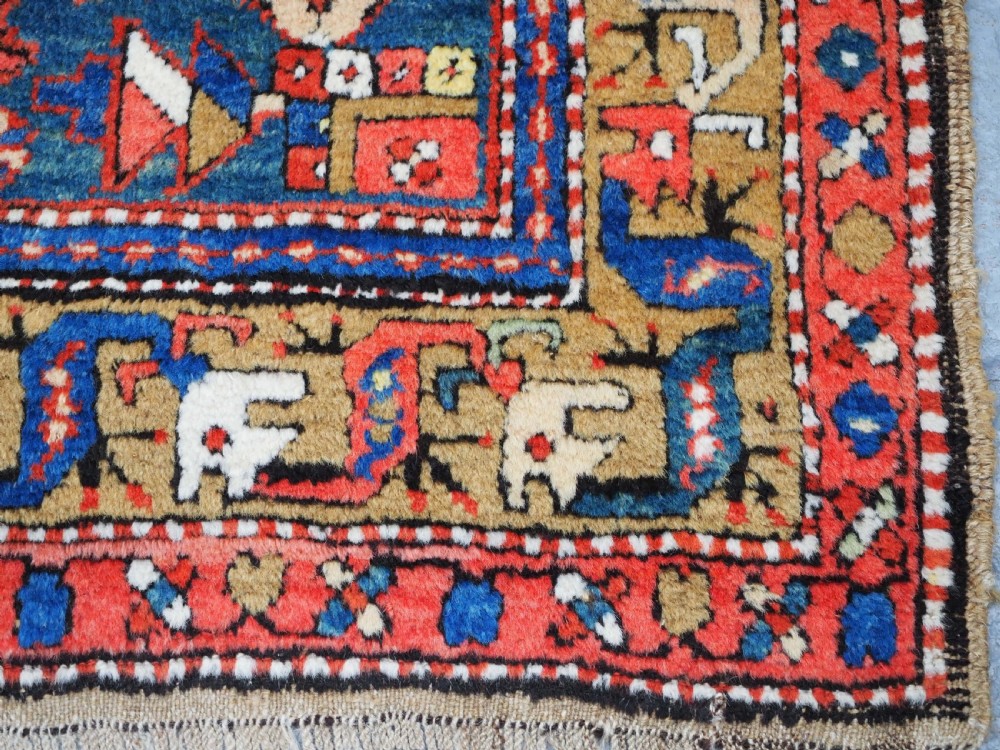 A long hand-knotted Persian Heriz carpet runner featuring geometric diamond medallions in navy blue and terracotta red wool. View XV