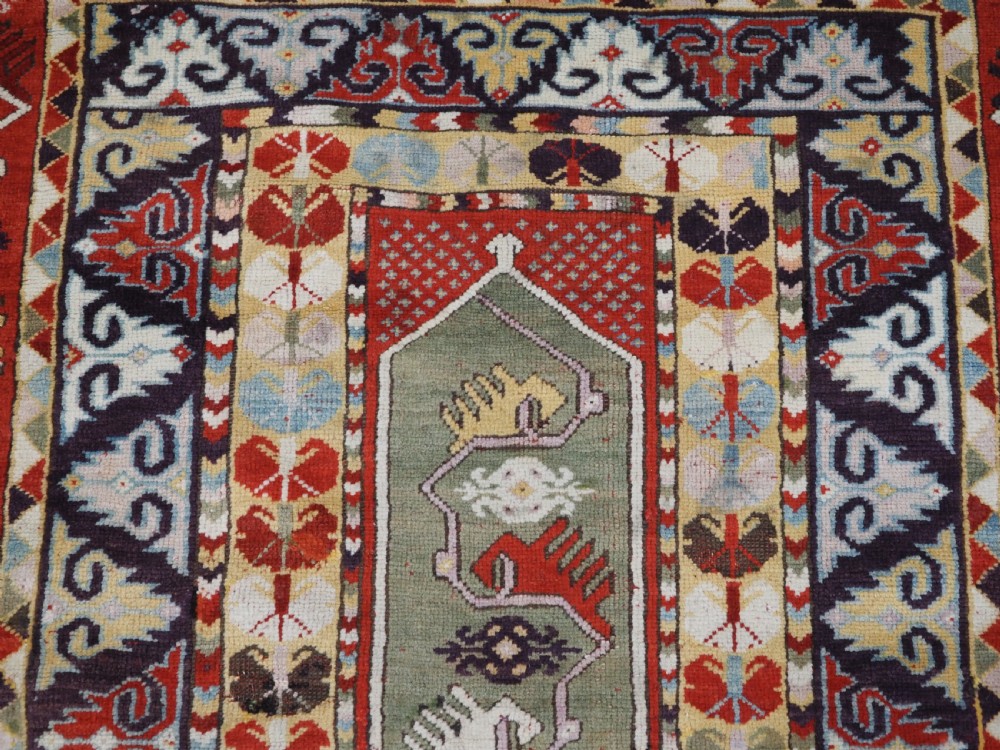 ANTIQUE TURKISH MILAS RUG OF SCARCE DESIGN, SUPERB COLOUR, CIRCA 1890. View VIII