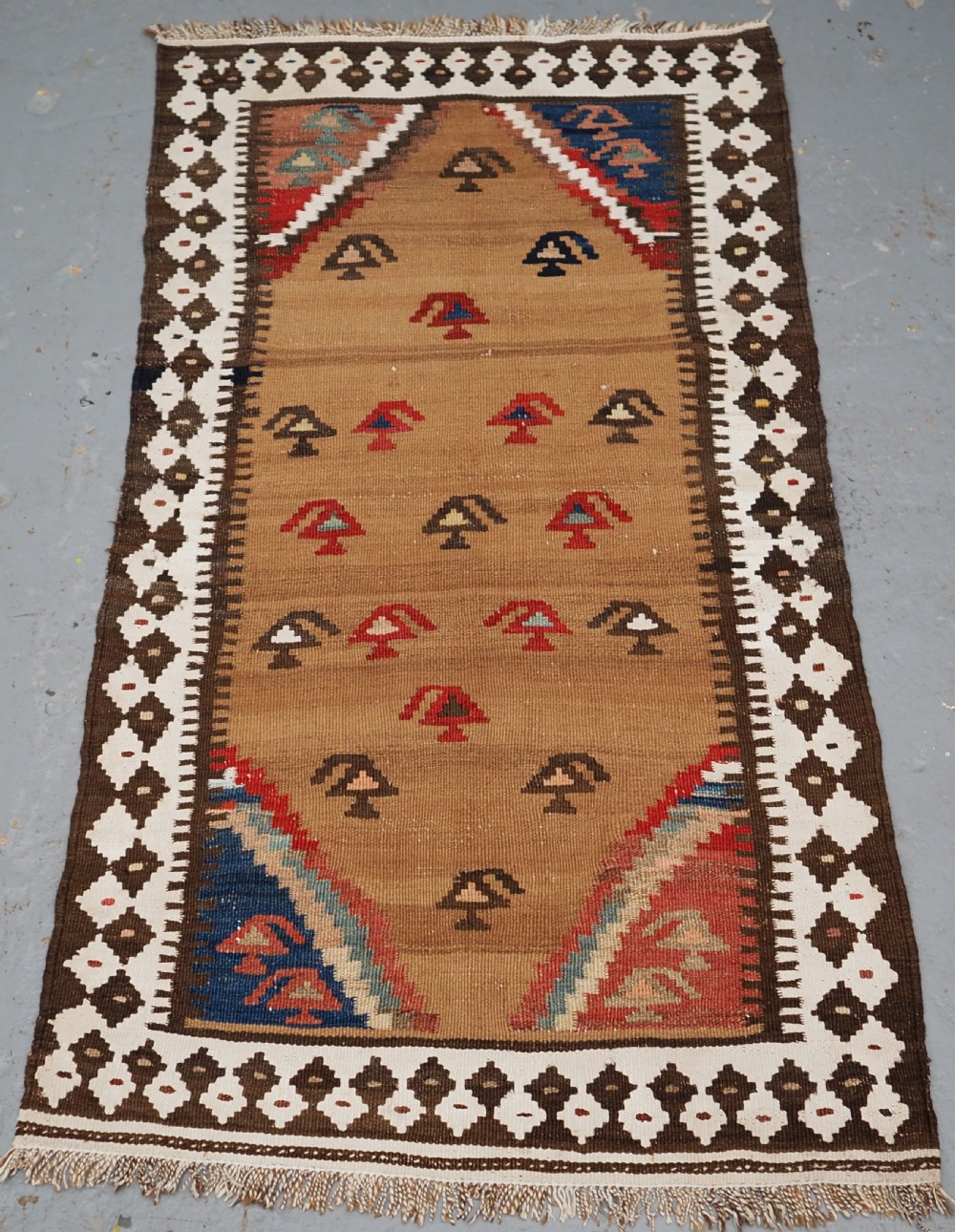ANTIQUE SMALL TRIBAL KILIM BY THE LURI OR BAKHTIARI, CAMEL WOOL AND COTTON, CIRCA 1900.