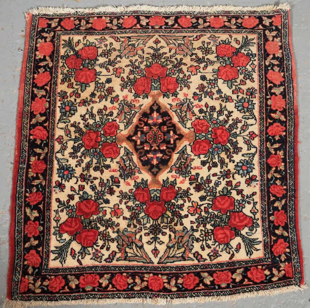 ANTIQUE BIJAR RUG OF SMALL SQUARE PUSHTI SIZE, FLORAL DESIGN, CIRCA 1890.