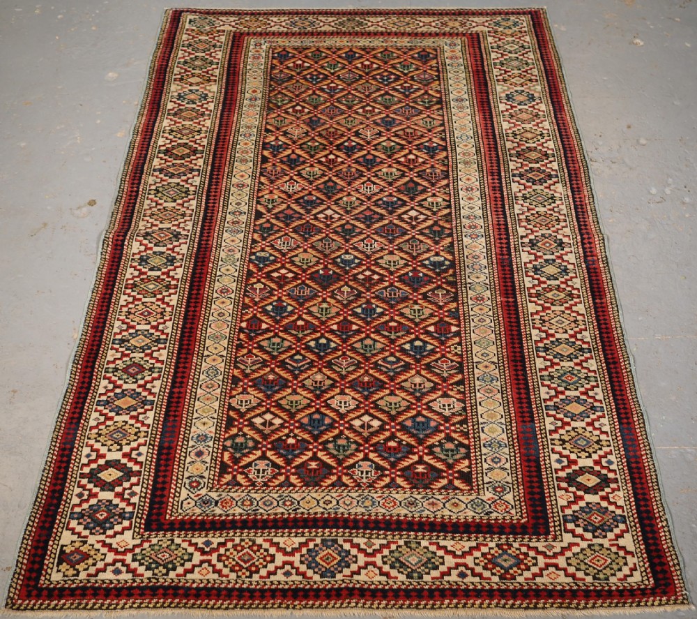 ANTIQUE CAUCASIAN KUBA SHIRVAN RUG OF FLORAL LATTICE DESIGN, CIRCA 1880.