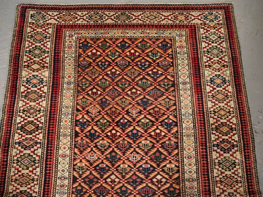 ANTIQUE CAUCASIAN KUBA SHIRVAN RUG OF FLORAL LATTICE DESIGN, CIRCA 1880. View III