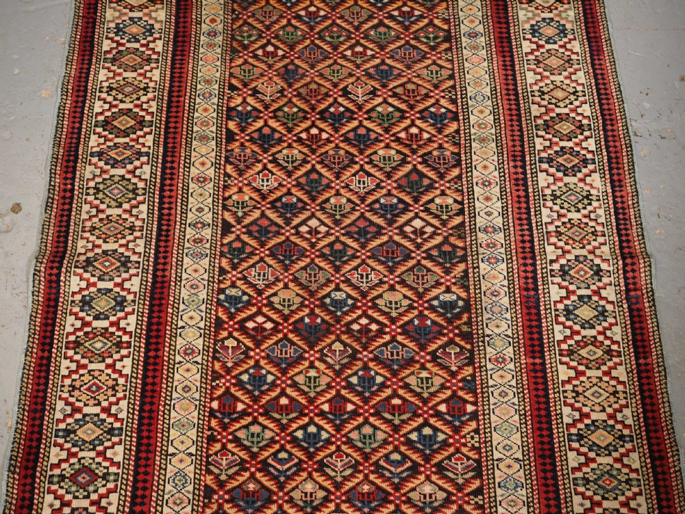 ANTIQUE CAUCASIAN KUBA SHIRVAN RUG OF FLORAL LATTICE DESIGN, CIRCA 1880. View IV
