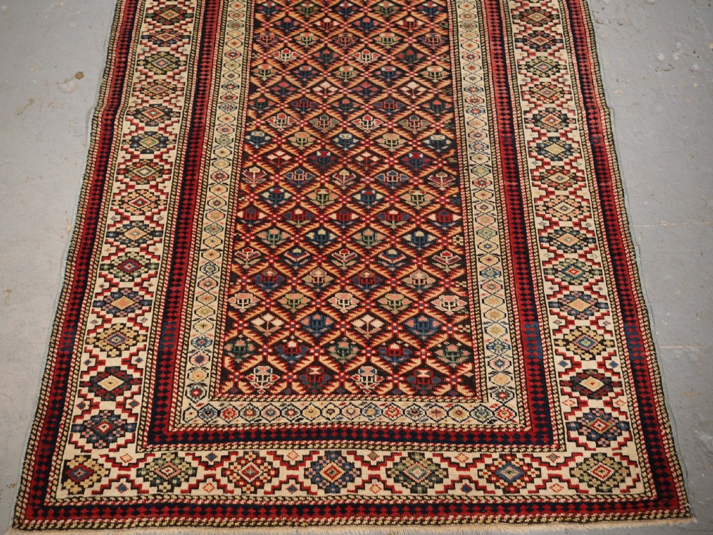ANTIQUE CAUCASIAN KUBA SHIRVAN RUG OF FLORAL LATTICE DESIGN, CIRCA 1880. View V
