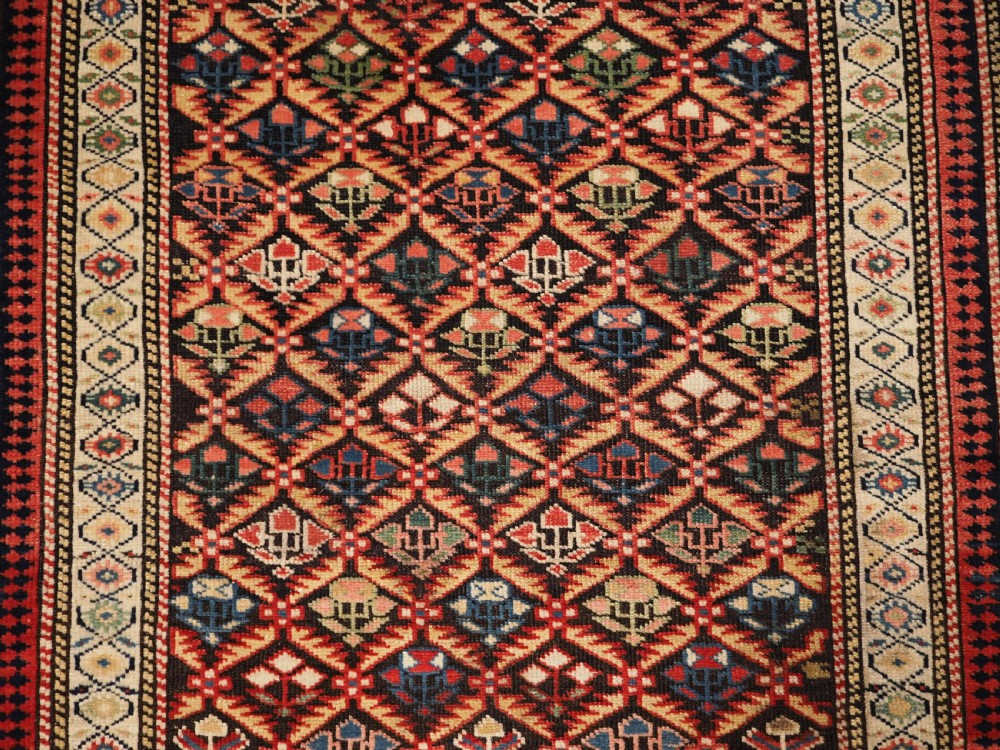 ANTIQUE CAUCASIAN KUBA SHIRVAN RUG OF FLORAL LATTICE DESIGN, CIRCA 1880. View IX