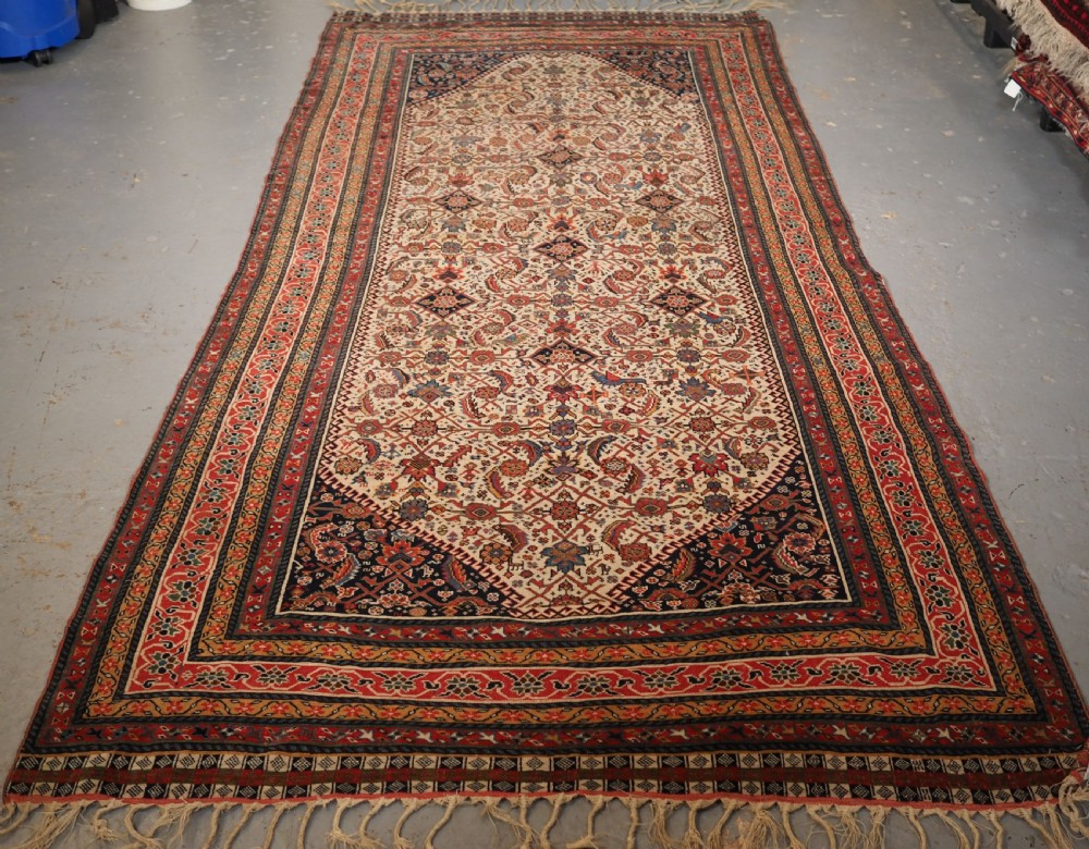 ANTIQUE QASHQAI LONG RUG, IVORY GROUND HERATI DESIGN WITH TIBAL ELEMENTS,  CIRCA 1870.