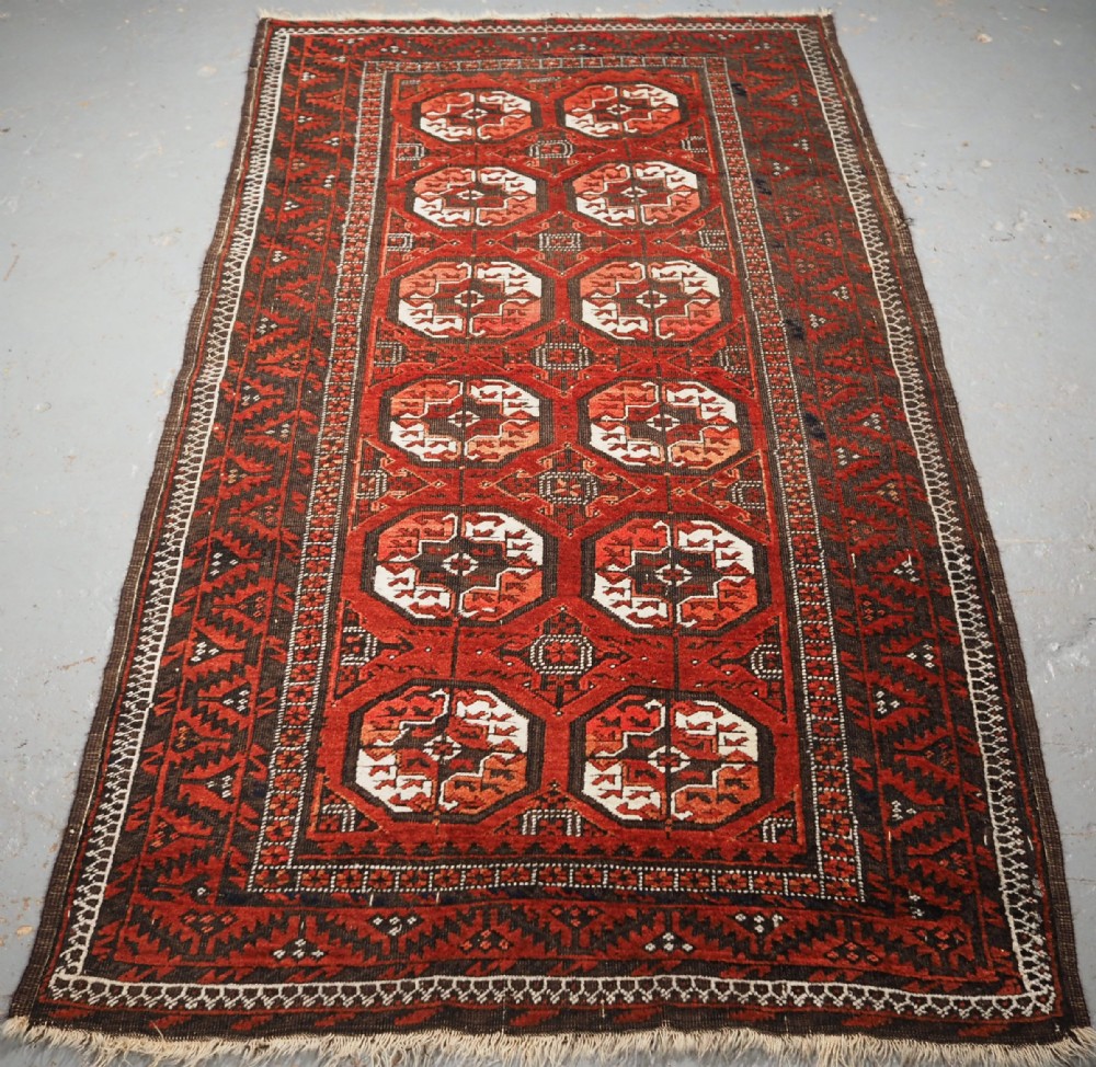 ANTIQUE MAHDAD KHANI BALUCH RUG, LARGE TURKMEN GULS, CIRCA 1900.