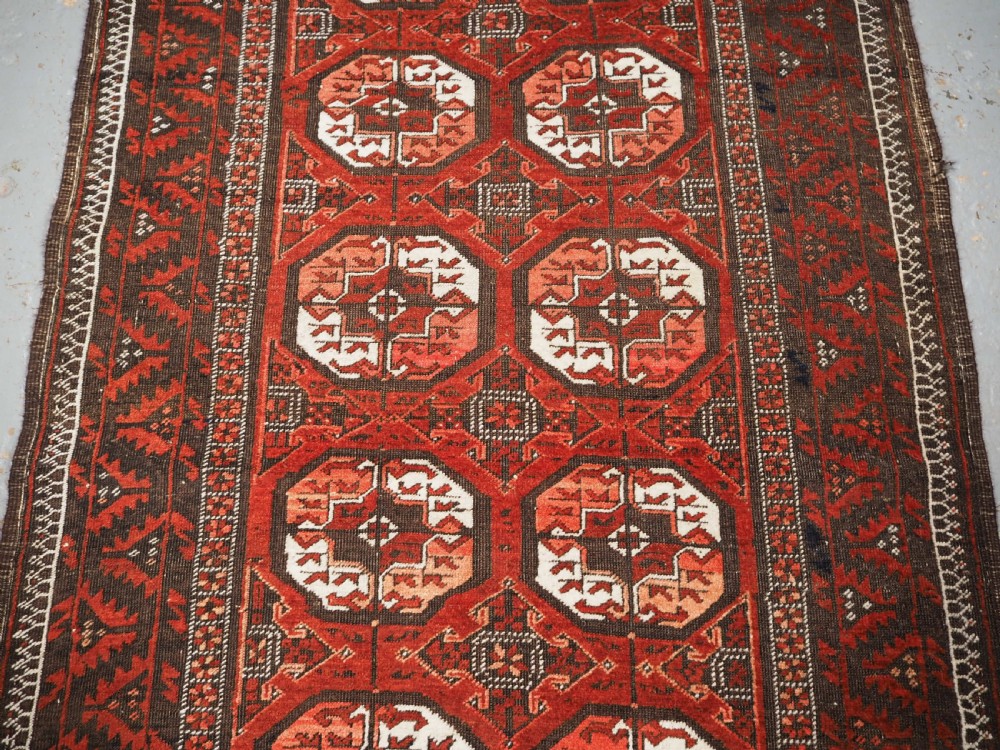 ANTIQUE MAHDAD KHANI BALUCH RUG, LARGE TURKMEN GULS, CIRCA 1900. View IV
