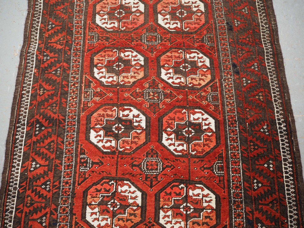 ANTIQUE MAHDAD KHANI BALUCH RUG, LARGE TURKMEN GULS, CIRCA 1900. View V