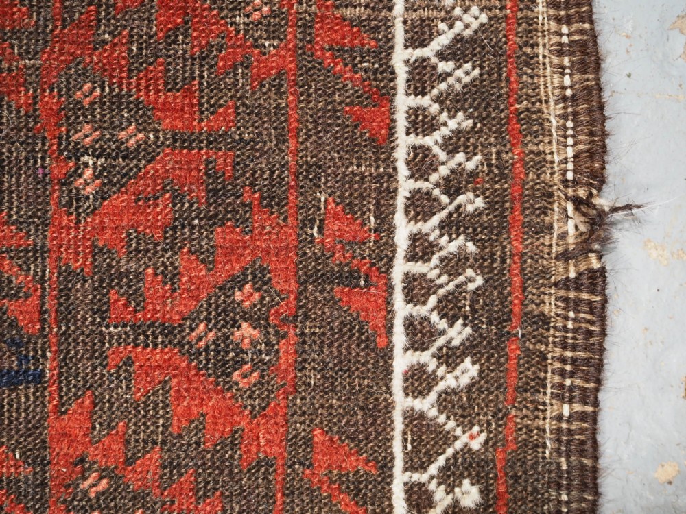 ANTIQUE MAHDAD KHANI BALUCH RUG, LARGE TURKMEN GULS, CIRCA 1900. View X