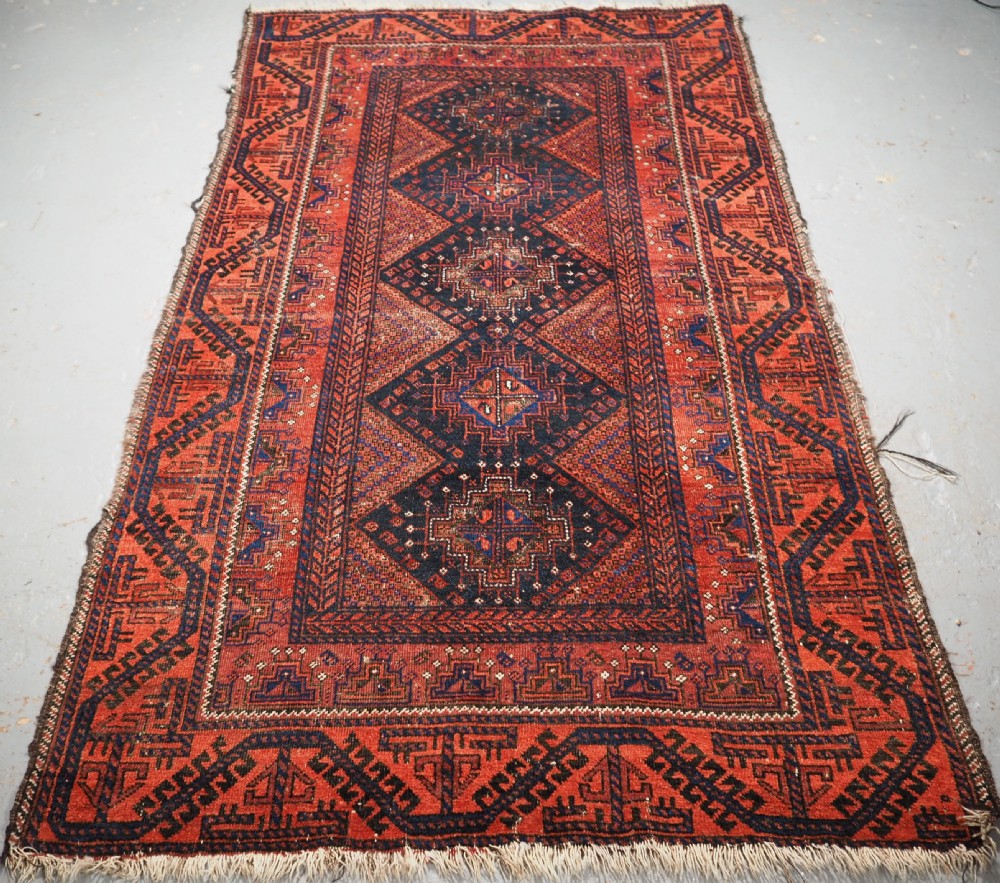 ANTIQUE FERDOWS BALUCH RUG OF SCARCE DESIGN, CIRCA 1900.