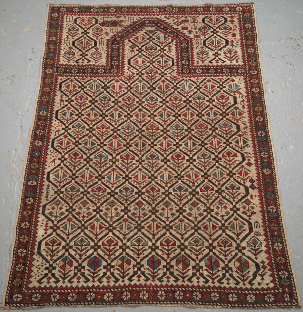ANTIQUE CAUCASIAN DAGHESTAN PRAYER RUG, IVORY GROUND LATTICE, CIRCA 1880.