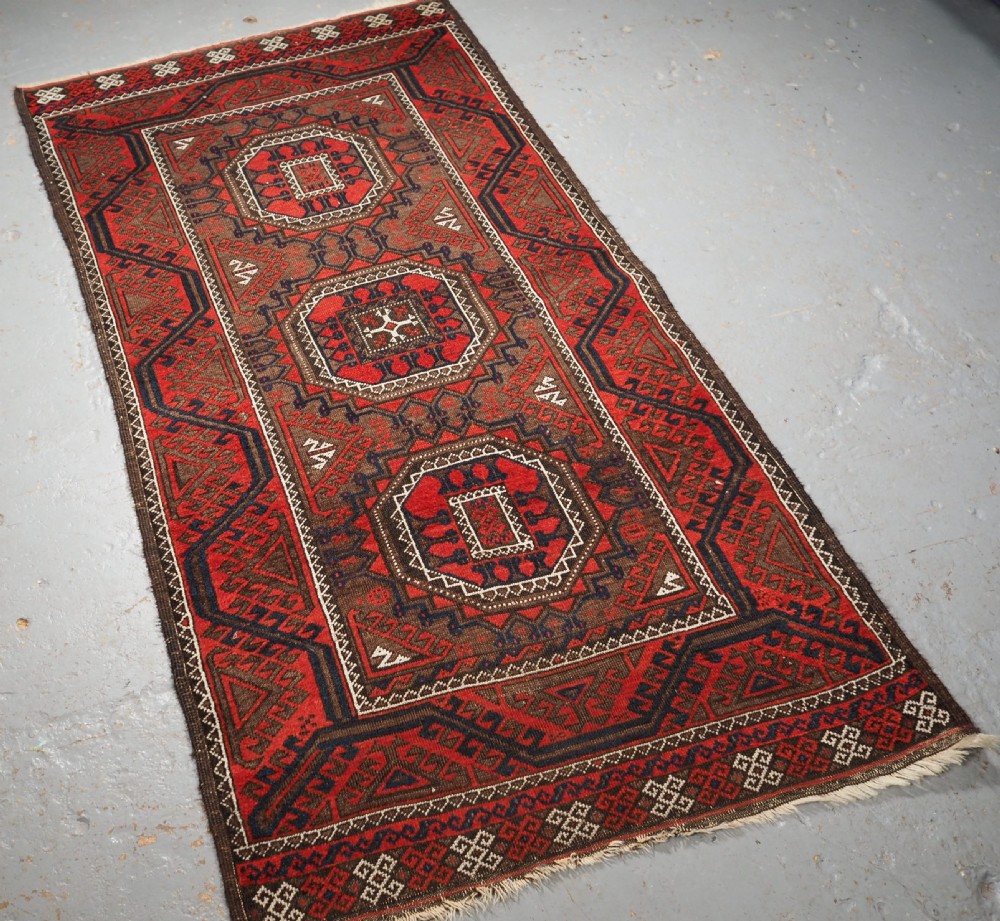 ANTIQUE SALAR KHANI BALUCH RUG, TURRETED GUL DESIGN, CIRCA 1900. View II
