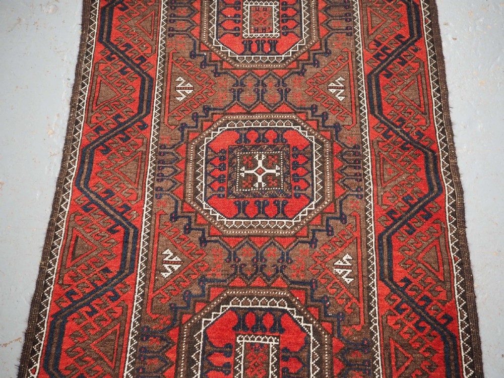 ANTIQUE SALAR KHANI BALUCH RUG, TURRETED GUL DESIGN, CIRCA 1900. View IV