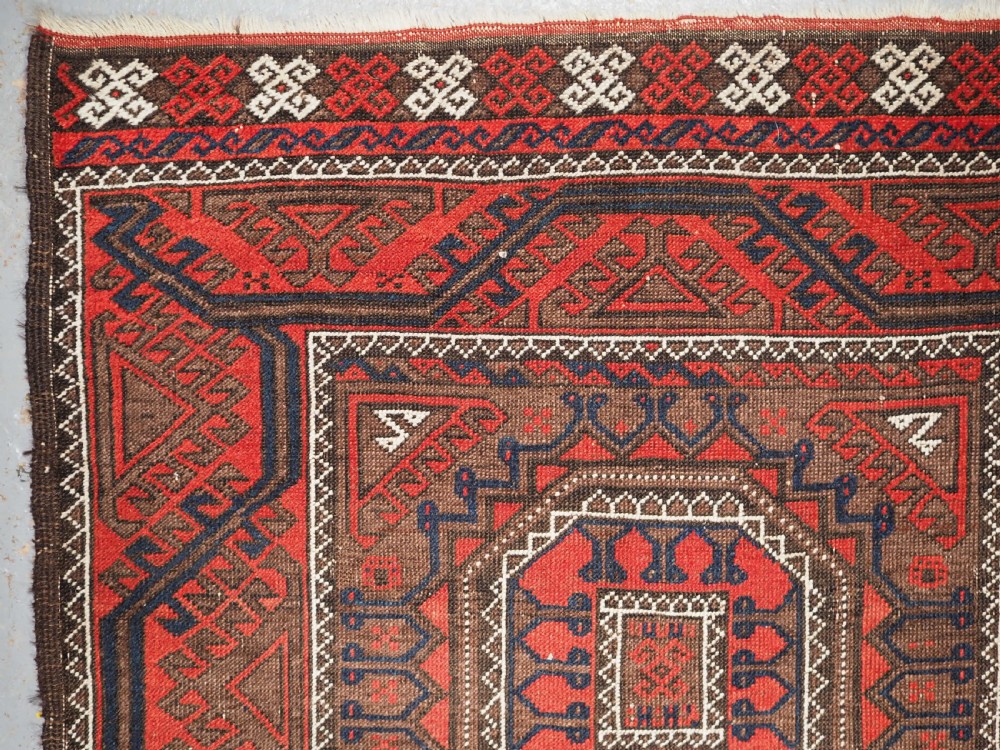ANTIQUE SALAR KHANI BALUCH RUG, TURRETED GUL DESIGN, CIRCA 1900. View VI