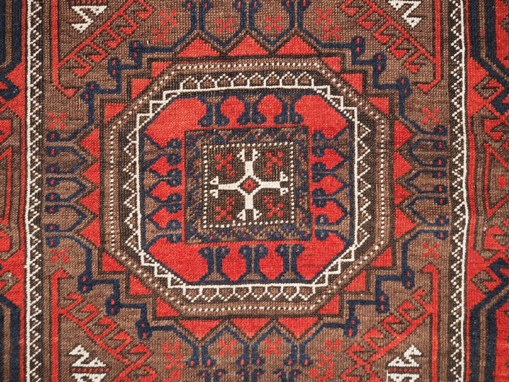 ANTIQUE SALAR KHANI BALUCH RUG, TURRETED GUL DESIGN, CIRCA 1900. View VIII