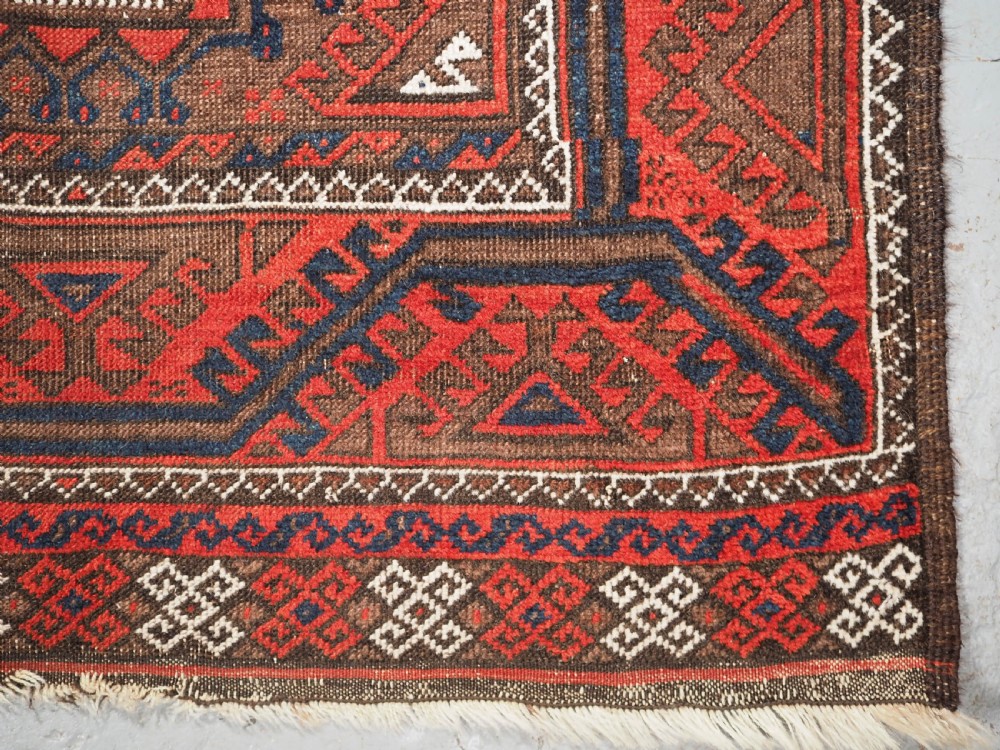ANTIQUE SALAR KHANI BALUCH RUG, TURRETED GUL DESIGN, CIRCA 1900. View IX