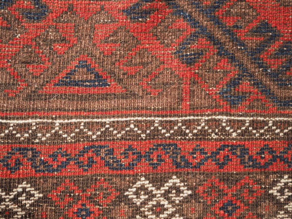 ANTIQUE SALAR KHANI BALUCH RUG, TURRETED GUL DESIGN, CIRCA 1900. View X