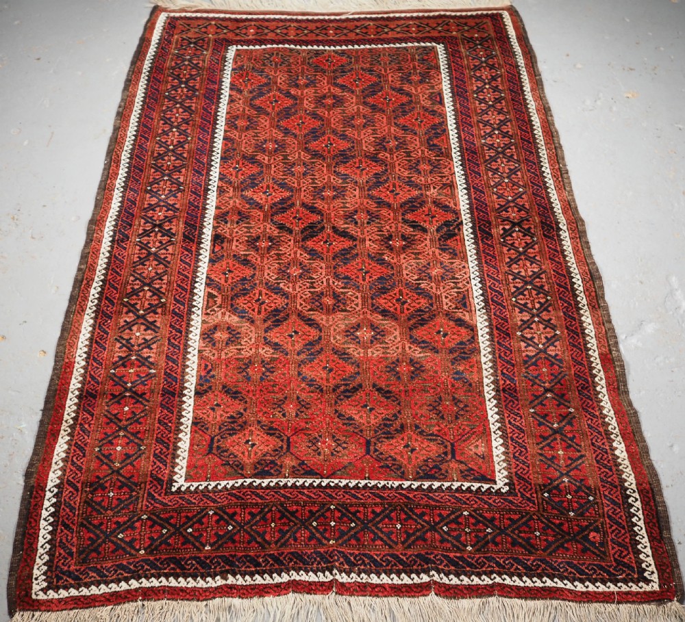 ANTIQUE BALUCH RUG WITH LATTICE DESIGN, SUPERB RUG, CIRCA 1880.