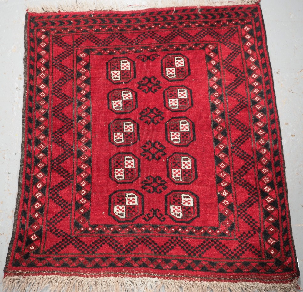 OLD AFGHAN VILLAGE RUG OF SMALL MAT SIZE, CIRCA 1930.