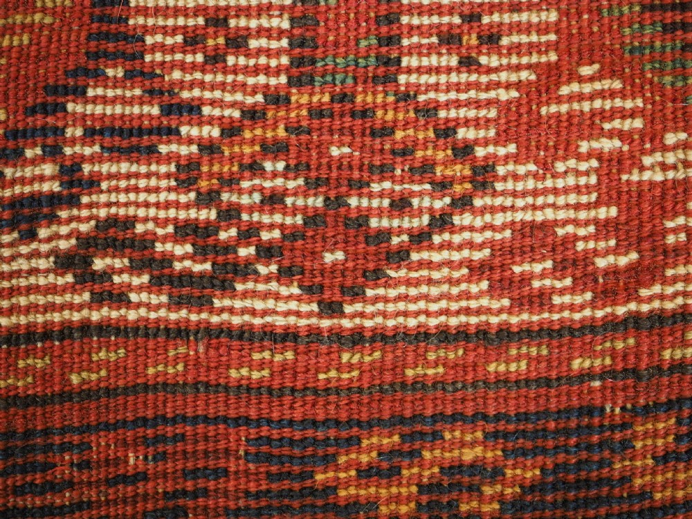 An antique Persian Qashqai Shekarlu wool rug featuring geometric diamond medallions in deep red, navy blue, and cream shades. View XXVIII
