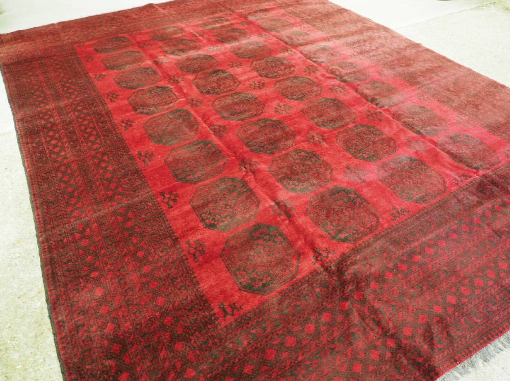 OLD AFGHAN VILLAGE CARPET, LARGE ROOM SIZE, CIRCA 1930.