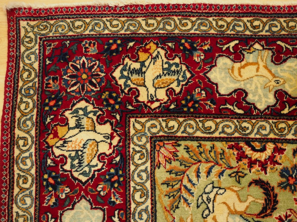 OLD TABRIZ RUG WITH HUNTING DESIGN ON A GREEN GROUND, CIRCA 1930. View IV