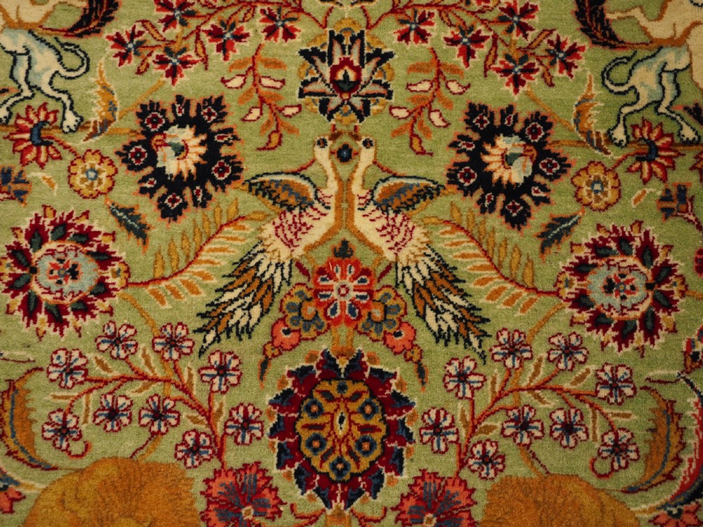 OLD TABRIZ RUG WITH HUNTING DESIGN ON A GREEN GROUND, CIRCA 1930. View V