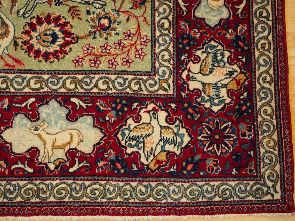 OLD TABRIZ RUG WITH HUNTING DESIGN ON A GREEN GROUND, CIRCA 1930. View VI