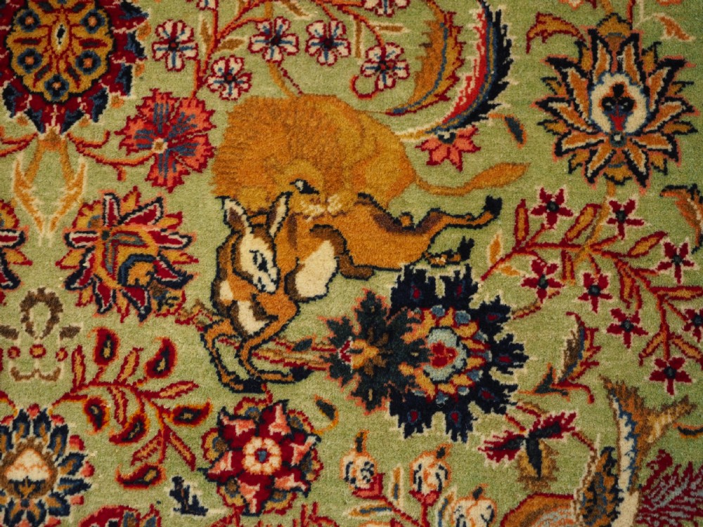 OLD TABRIZ RUG WITH HUNTING DESIGN ON A GREEN GROUND, CIRCA 1930. View VIII